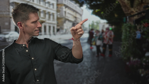 Foto Man points finger at a flower stall on a busy city street among pedestrians, fingertip and wrist visible; contemplation