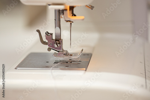 Schilderij op canvas Sewing machine, stitching fabrics, needle close up, sewing and repairing clothin