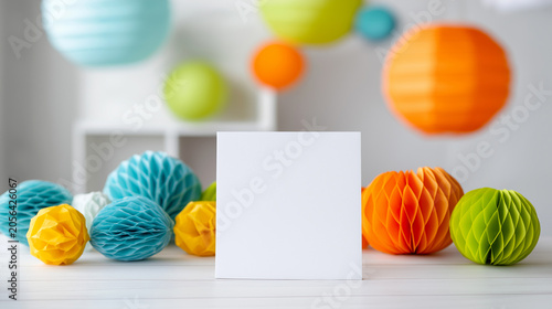 Blank white greeting card with colorful party decorations