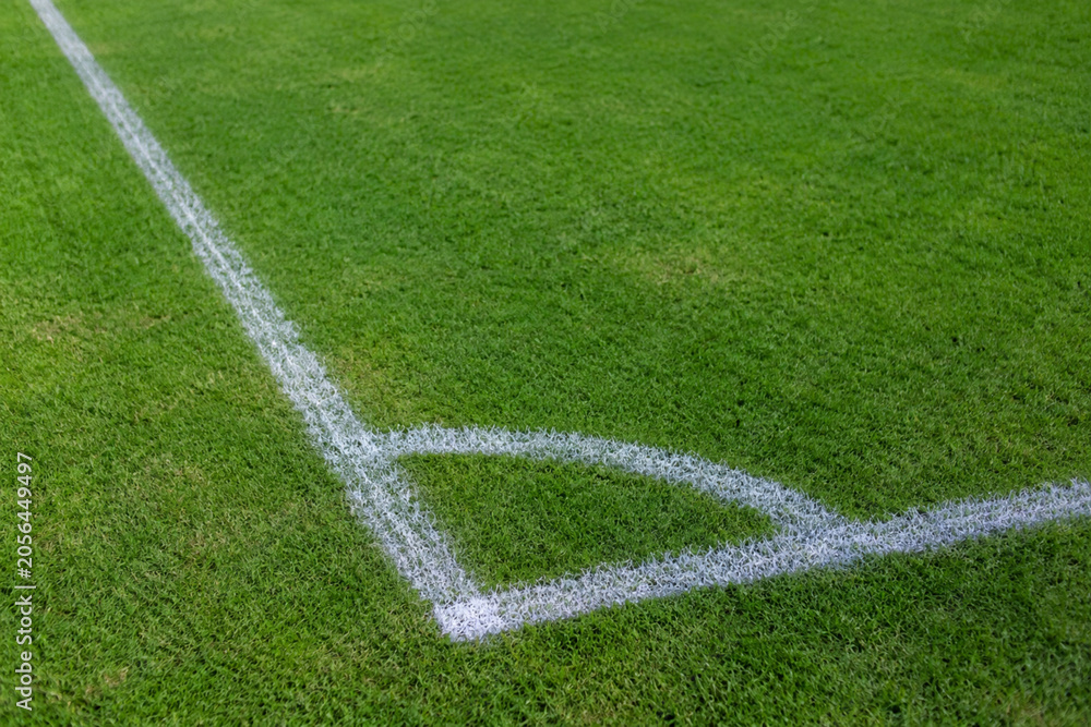 Fototapeta premium Football Field Corner Marking on Fresh Green Grass Pitch Ready for Professional Sports Competition