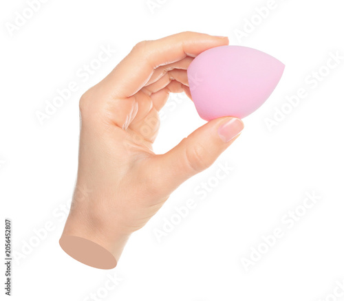 Woman hand holds cosmetic sponge, isolated on transparent background, cosmetics and visage concept. Contemporary art
