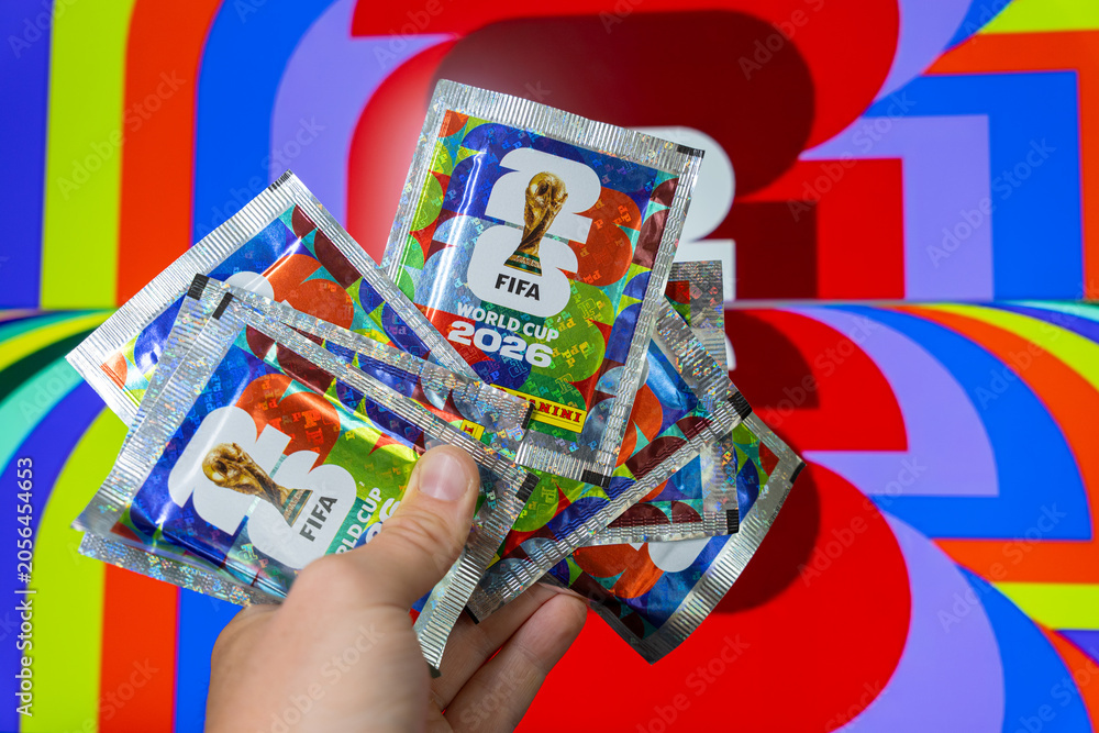 Naklejka premium Hand holding Panini FIFA World Cup 2026 trading card sticker packs, foil booster packets for football soccer tournament collectors