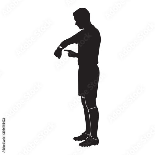 Konstfotografi Soccer referee pointing at wristwatch signaling stoppage time during professiona