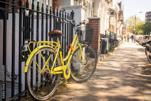Photography LONDON– yellow bicycle on residential street in upmarket Kensington west london