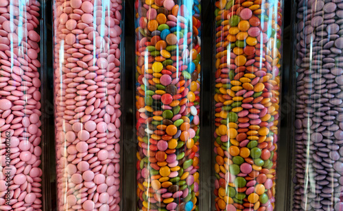 Bild auf Leinwand Colorful candies in transparent tubes displayed in a shop for customers to choos