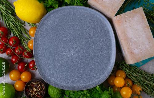 Fresh food arranged around an empty gray plate on a light background. Top view, copy space, diet concept. Food background