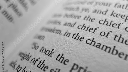 Moving along bible page macro close up scripture text christian faith spiritual reading holy bible background