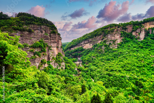 Ancient Jianmen Guanlou gate tower surrounded by steep mountain cliffs in Jianmen Pass, Sichuan, China
