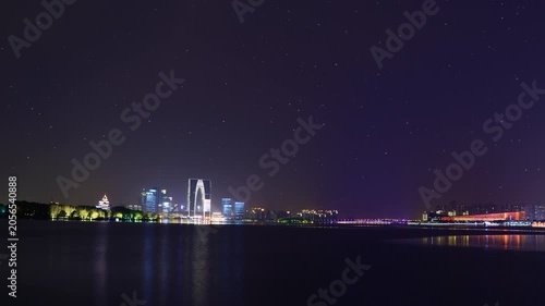 Suzhou Gate to the East skyline reflected on Jinji Lake at night in Suzhou, Jiangsu, China