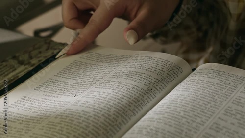 young conservative asian Woman Reading the Bible at table with bread food and drink indoors