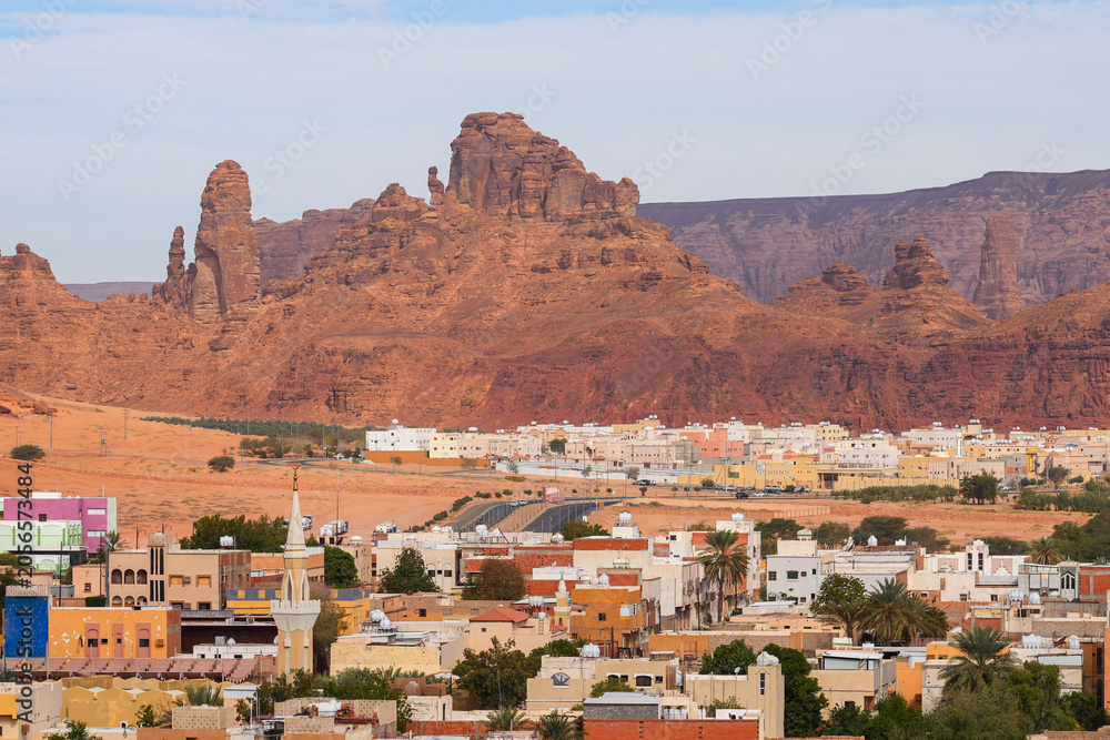 Obraz premium AlJadidah district of AlUla town against red sandstone cliffs, Saudi Arabia