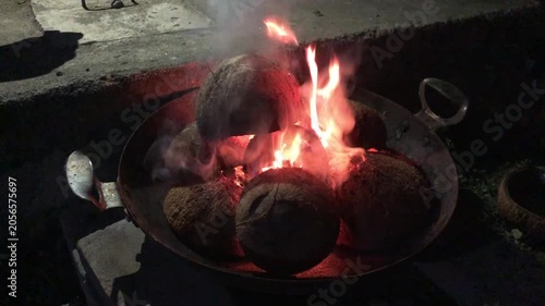 burning dried coconut  on a stove