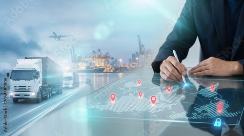 Global logistics network concept with freight trucks, cargo port, airplane and business planner tracking routes