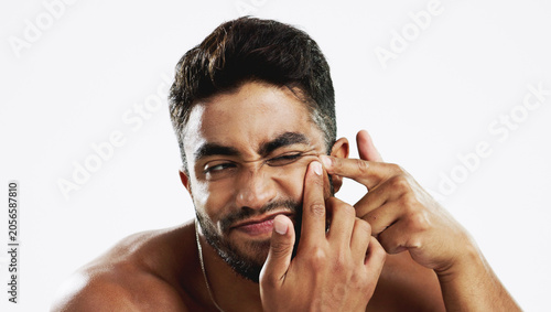 Fotografía Man, skincare and squeeze acne in studio for breakout, scratch spot and facial scar on white background