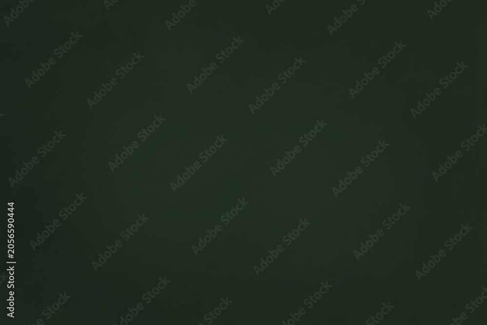 Fototapeta premium A clean full-frame texture of a blank green school chalkboard or blackboard. Minimalist dark green background 