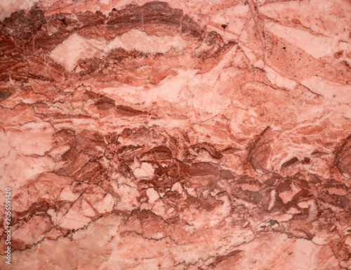 A soft pink marble background with swirls of earthy tones. A detailed, close-up design mimics natural patterns. Ideal for architecture and interior design
