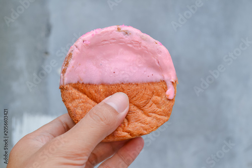 Cromboloni, Croissant Bomboloni. Round New York Roll with Strawberry Sauce on hand.