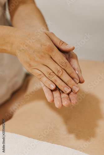 Close up of hands with massage oil. Rubbing with oil before massage.