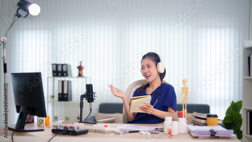 Cuadro en lienzo Young Asian woman recording educational podcast episode with microphone and note