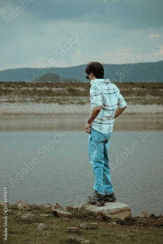 boy looking at the dam in india