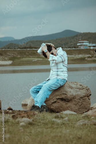 young men sitting on the river