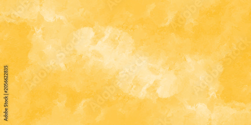 Yellow watercolor wash background with soft cloud like textures and blended gradients ochre amber golden texture