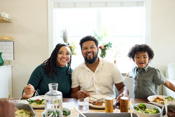 Family Enjoys Meal Together in Dining Room