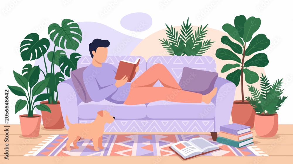 Obraz premium Relaxed man reading book on sofa with dog in a cozy living room