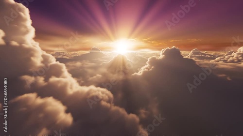 Aerial View of Clouds at Sunset with Golden Light Rays.