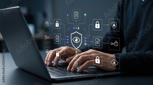 Professional typing on laptop to manage secure network with encrypted document icons and glowing shield interface, cybersecurity concept, cloud computing, data modern technology business concept