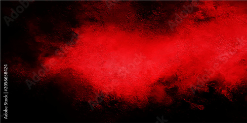 Φωτογραφία Intense red powder explosion against a stark black background, creating a dramat