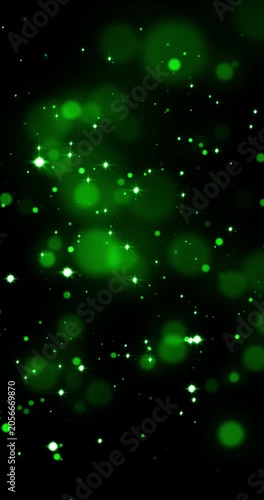 Green lights, glittering shiny green particles and shimmering bokeh light spheres. Suitable for backgrounds, overlays, or modern art concepts in graphic design. Abstract bokeh background