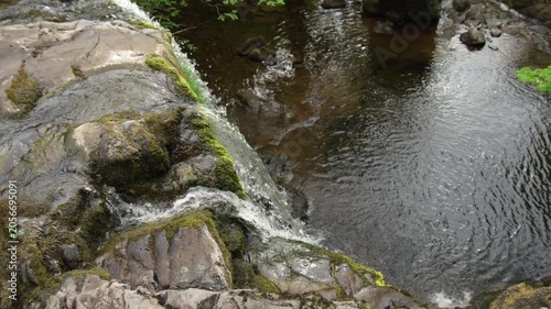 Top Down View of Waterfall Cascading Into River Pool