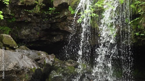 Waterfall Water Droplets Falling in Front of Dark Cave