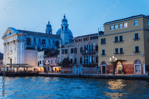 Illuminated waterfront churches at blue hour, Venice, Italy