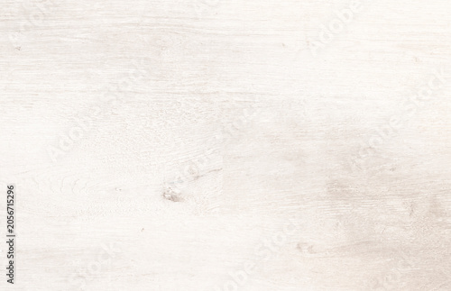 White washed wood texture background with visible grain and knot. Light rustic wooden plank surface close-up, warm tone..