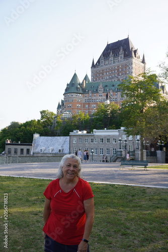 senior woman taking a picture in front of frontenac castle