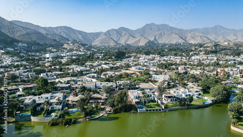 Bilde på lerret Drone photograph of luxury waterfront villas and private mansions lining the calm waters of La Planicie private lagoon in La Molina