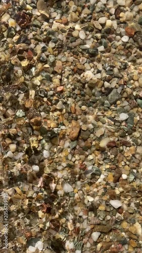 Crystal Clear Water Over Multi-Colored Pebbles