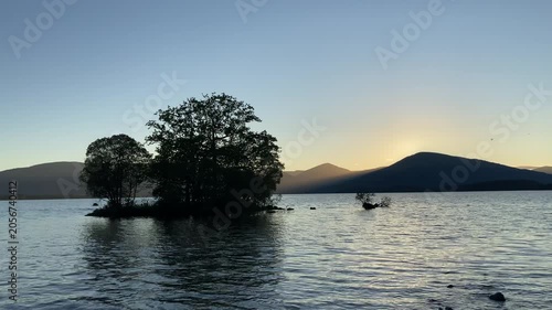 Silhouette of Island Trees on Lake at Sunset