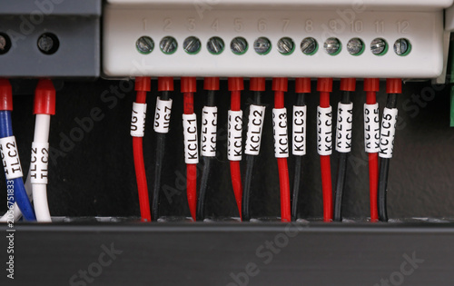 Marking electrical wiring wires with thermally printed nylon tape. 