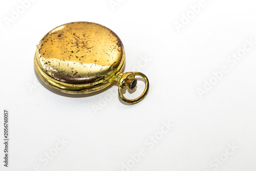 Tableau sur toile Old gold pocket watch case with worn scratched surface on a white background