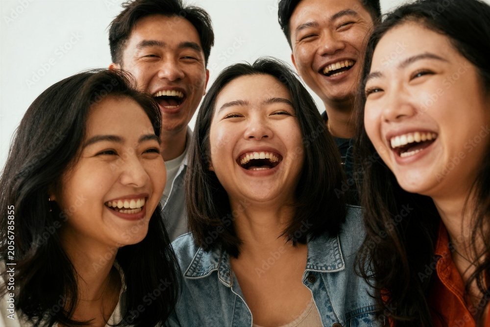 Fototapeta premium Young adults laughing together in indoor close up studio