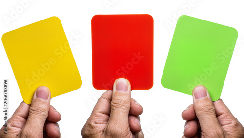 Canvas Print Isolated hands holding yellow, red, and green penalty cards for sports or decisi