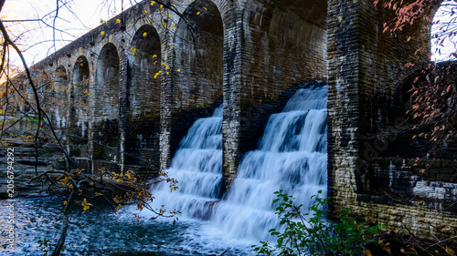 Crossville, Tennessee, USA:  Stone Arch Bridge, historic Byrd Creek Dam located at Cumberland Mountain State Park in Crossville. Two waterfalls descend from the dam bridge