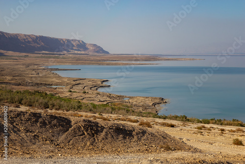 Canvas Print Scenic view of the Dead Sea coastline with salt deposits and arid desert mountai