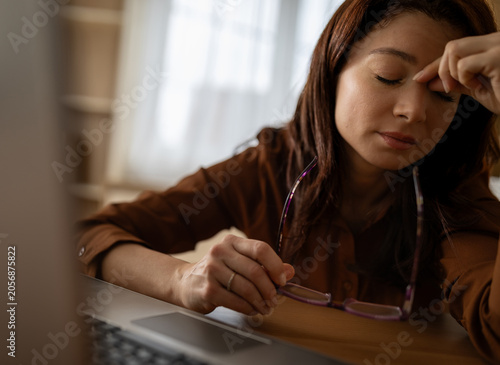 Working woman shows signs of fatigue at a desk