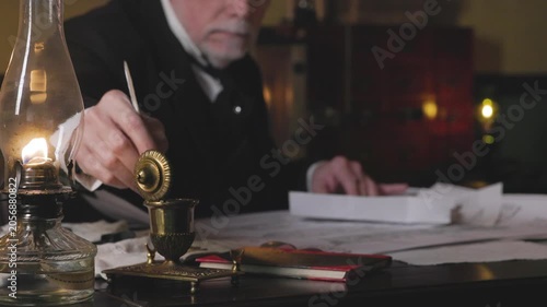 1800s man opens inkwell writes with dip pen focus on oil lamp