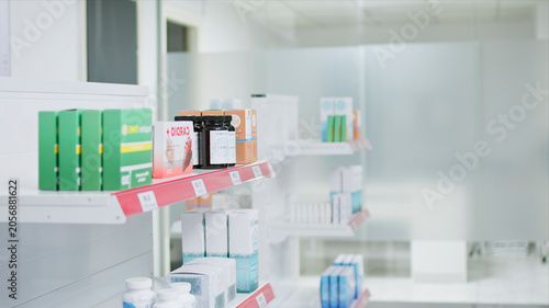 Bild auf Leinwand Selective focus of medicaments and supplements on shelves, empty pharmacy stacked with prescription medicine and medical supplies, with drugstore having antibiotics and pharmaceutics for sale