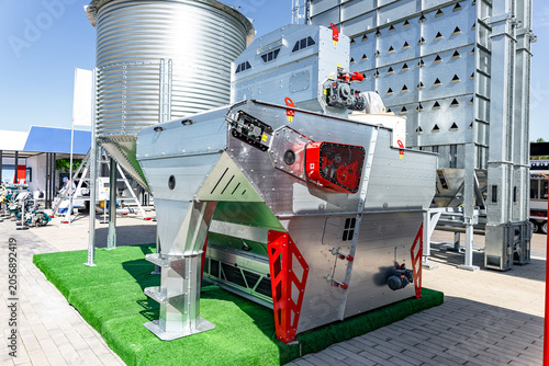 Obraz na plátne A large stainless steel industrial centrifuge sits on artificial grass outdoors at an exhibition area